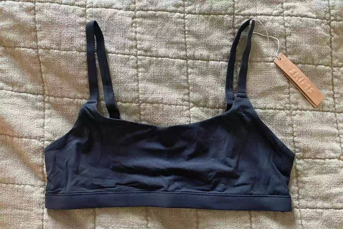 Skims Fits Everybody Scoop Bralette displayed on a blanket