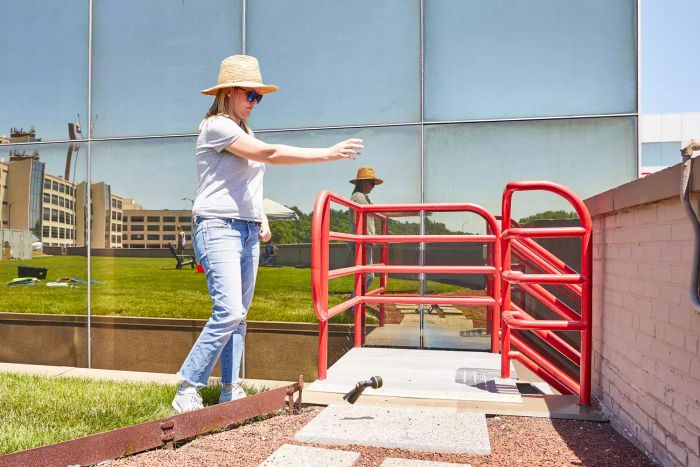 Person dropping the Melnor Rear Trigger Nozzle on a cement stepping stone during a test
