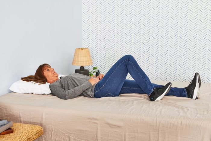 A person rests on The Company Store Contour Support Latex Pillow