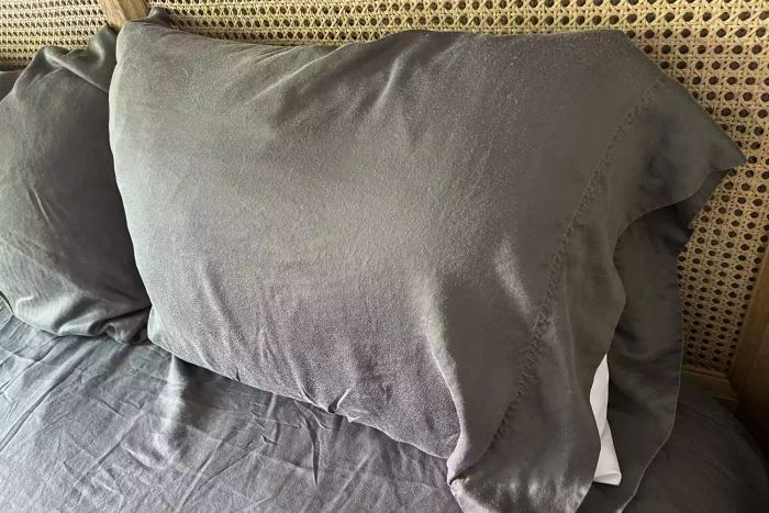 A pillow placed inside the Sheets & Giggles Eucalyptus Lyocell Sheets Set pillowcase