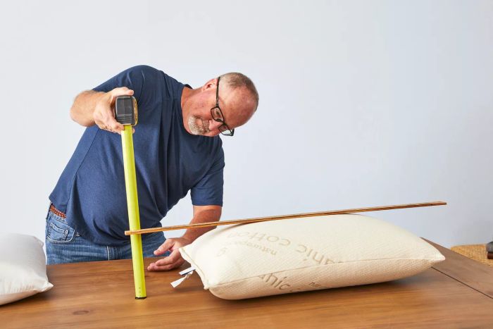 A person takes measurements of the Naturepedic Organic Solid Latex Pillow