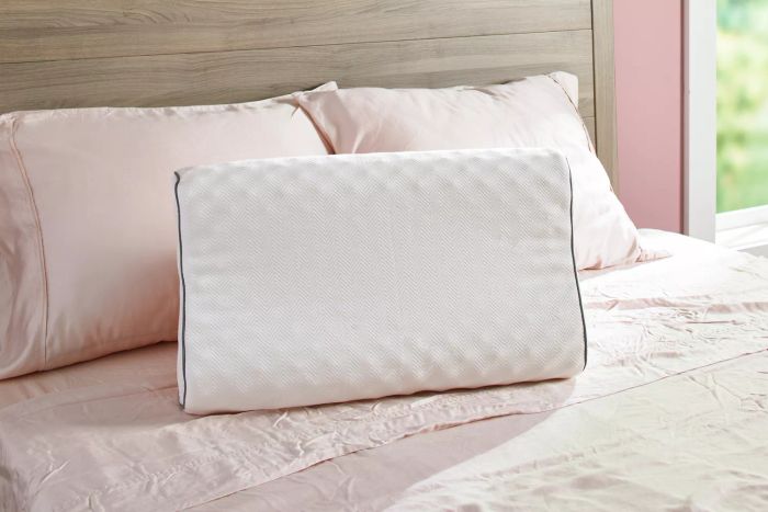 The Company Store Contour Support Latex Pillow placed on a bed