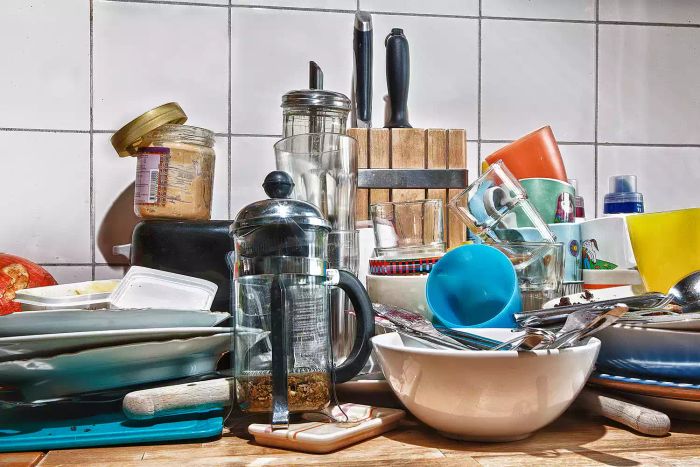 Various dirty kitchen tools scattered on a kitchen counter