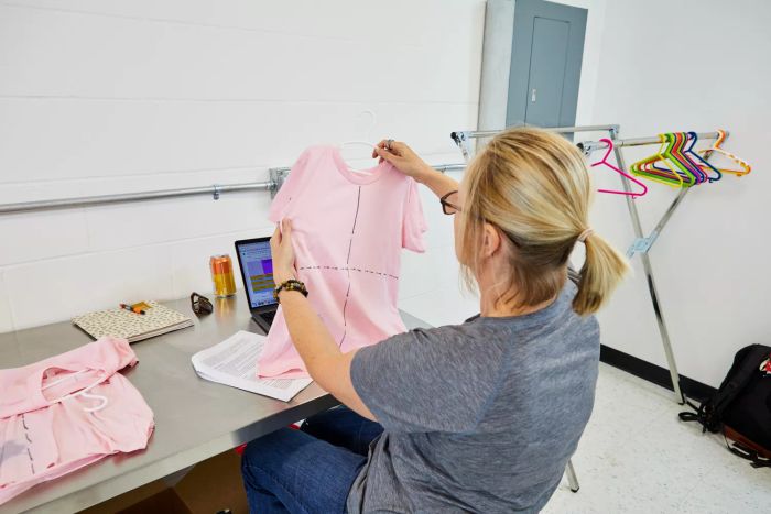 Woman hanging up a cloth after treating it with Seventh Generation Laundry Stain Remover