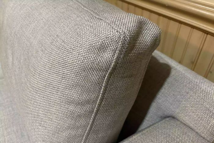 A close-up of the corner of a pillow cushion on the Crate & Barrel Barrett II 3-Seat Queen Sleeper