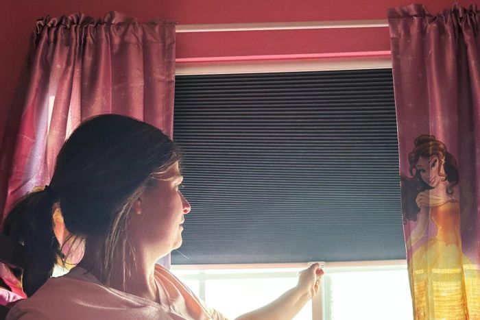 A person lowering the SBARTAR Cellular Shades Honeycomb Blinds in a residential environment
