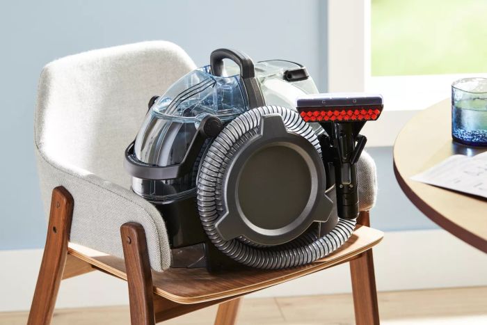 Bissell 3624 Spot Clean Pro Portable Carpet Cleaner showcased on a chair