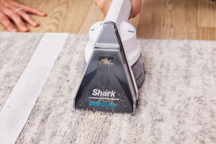 The Shark PX201 StainStriker Portable Carpet Cleaner on a rug