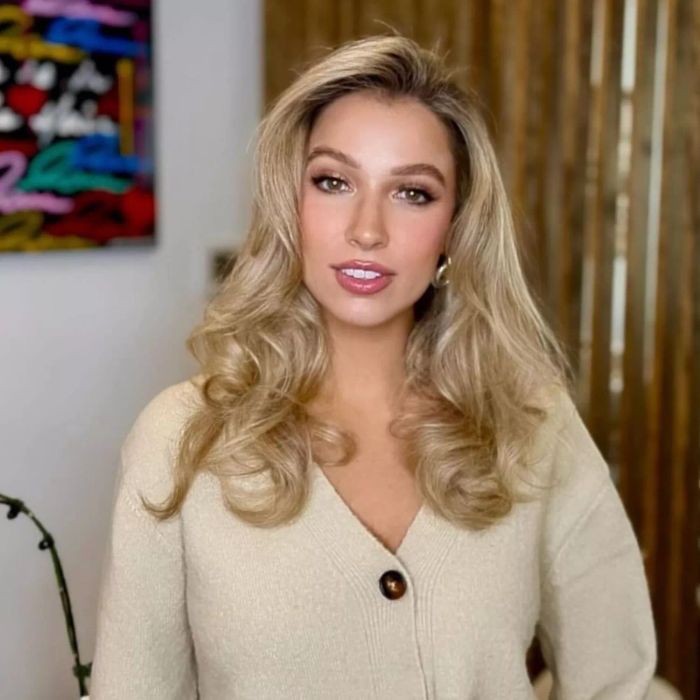 Medium-length blonde hair featuring voluminous curls and layered texture.