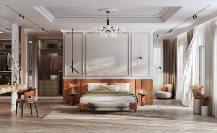 elegant bedroom featuring a spacious bed and suspended lighting