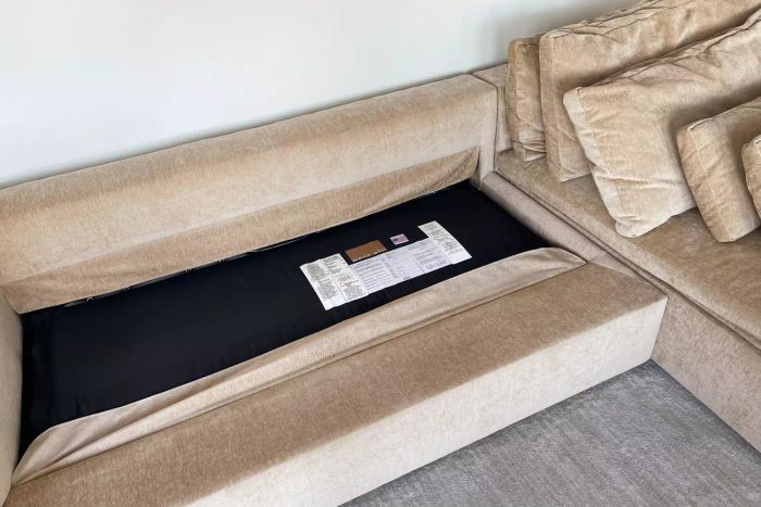 West Elm Harmony Modular 2-Piece Sleeper Sectional With Storage Chaise displayed in a home setting with cushions removed