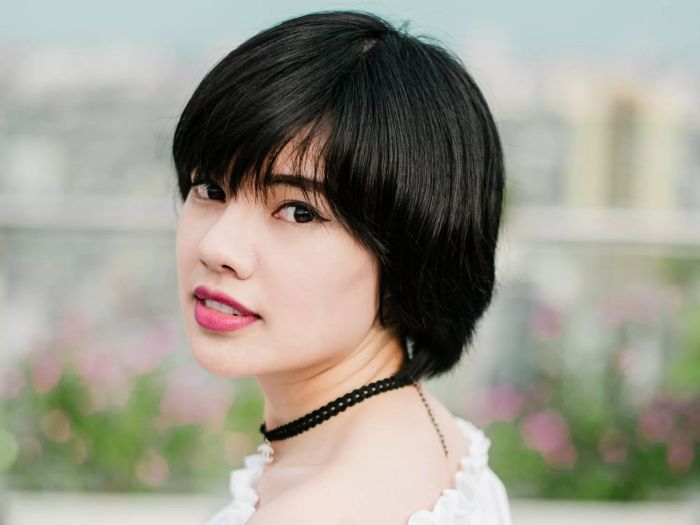 A woman showcasing a trendy bixie haircut: perfect for thick hair
