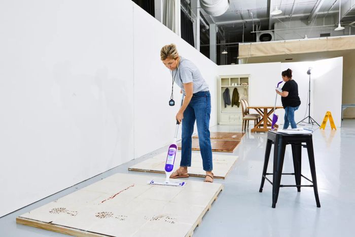 A person cleaning tile flooring with the Swiffer PowerMop Multi-Surface Kit