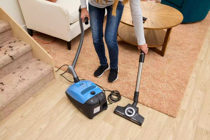 An individual assembling the Miele Classic C1 Turbo Team PowerLine