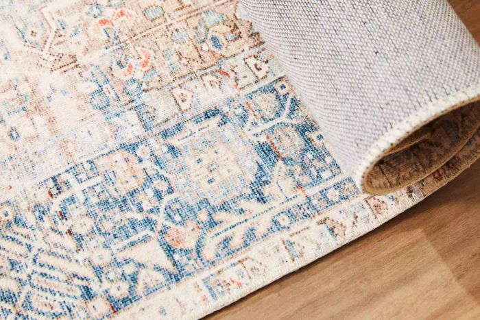 The Chris Loves Julia x Loloi Jules Oriental Area Rug folded over