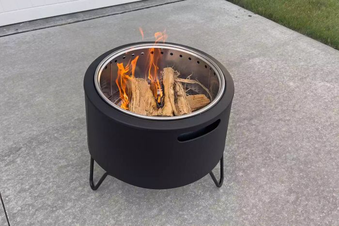 A flame burning inside the Tiki Social Smokeless Fire Pit
