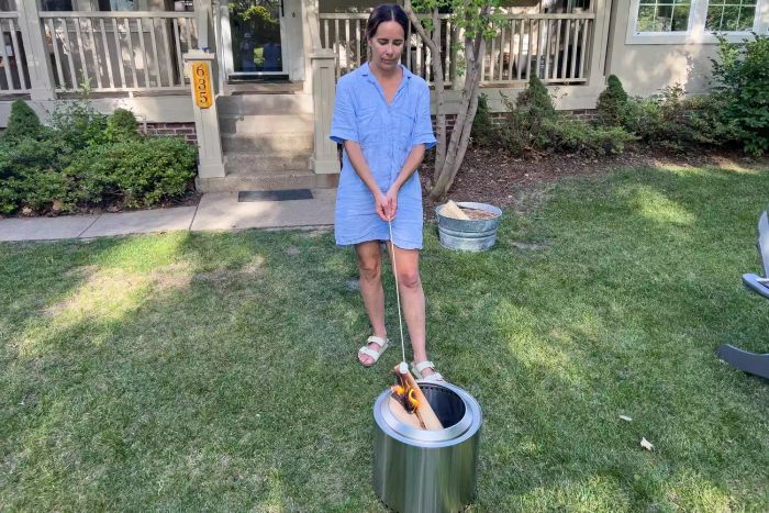 A person toasting a marshmallow over the flames of the Solo Stove Ranger 2.0 Fire Pit