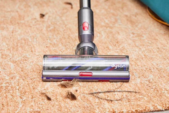 The Dyson V15 Detect Cordless Vacuum Cleaner effortlessly collecting dirt from a carpet