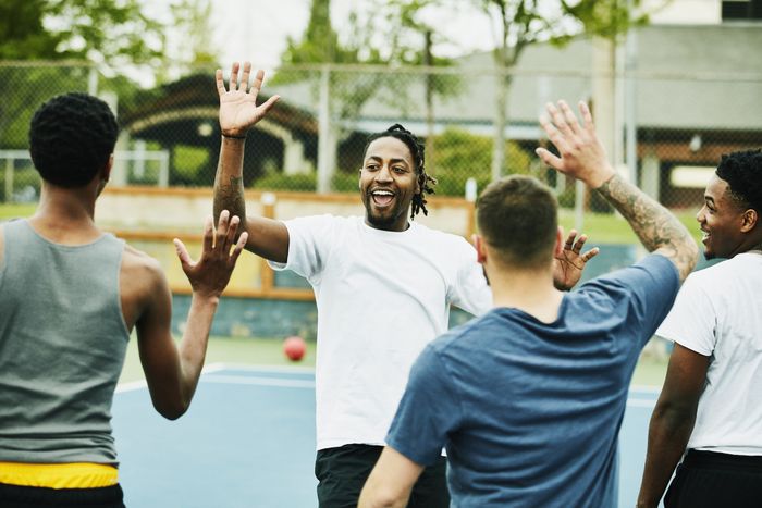 a group of friends playing basketball together