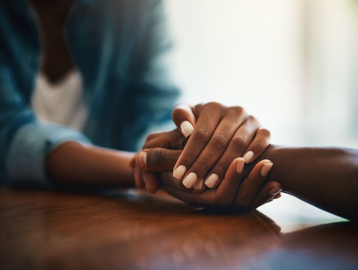 close-up of hands holding each other