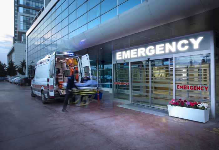An ambulance parked outside a hospital's emergency room