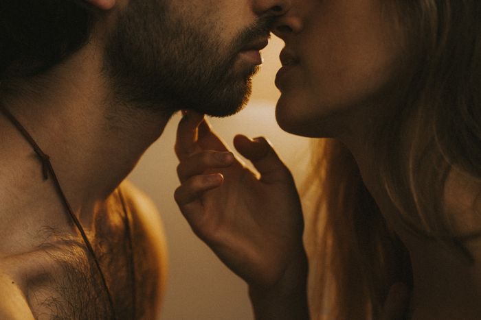 two individuals leaning in for a kiss