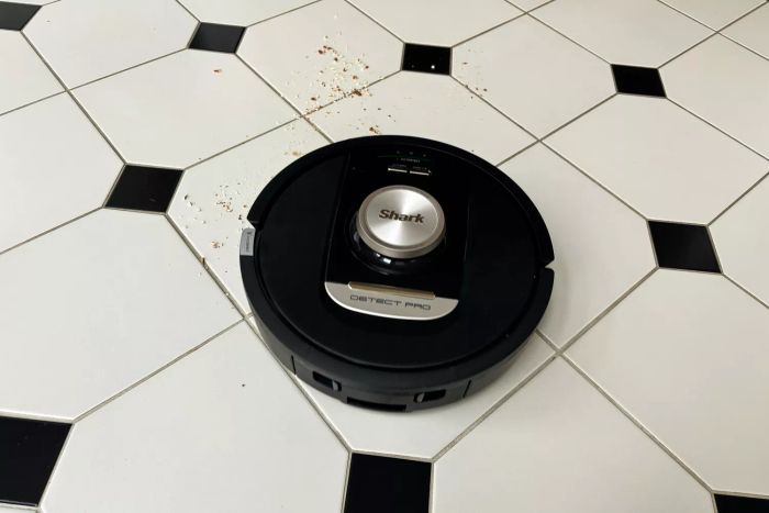 The Shark RV2820AE Detect Pro Self-Empty Robot Vacuum thoroughly cleans a tile floor.