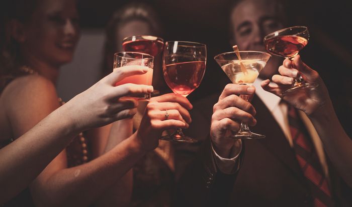 a group of people raising their glasses