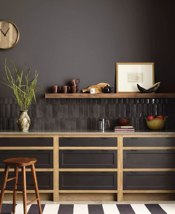 A kitchen painted in a deep gray-brown shade