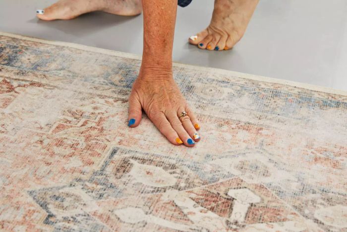 A person feeling the texture of the Ruggable Kamran Rug