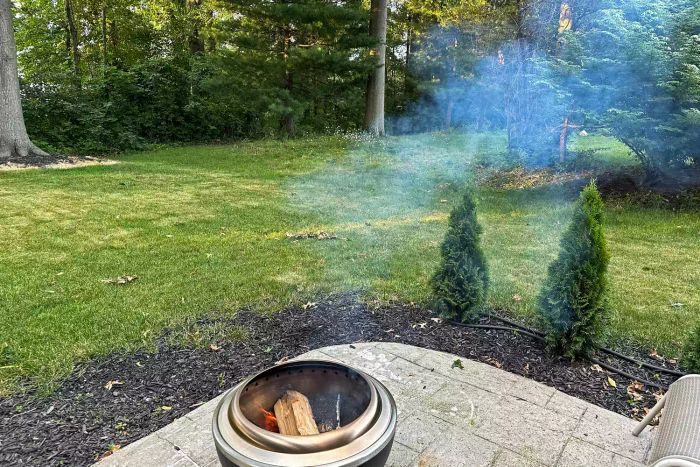 Smoke rising from the Cuisinart COH-800 Cleanburn Smokeless 24 Inch Fire Pit