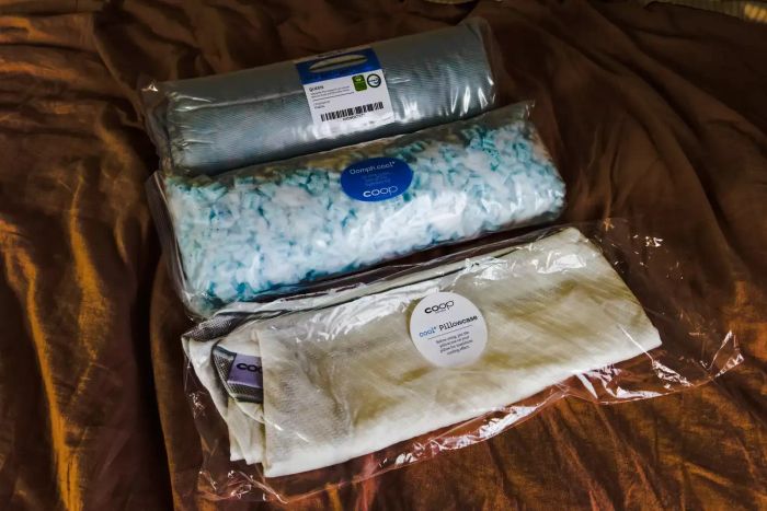 The components of the Coop EdenCool+ Adjustable Pillow displayed in plastic packaging