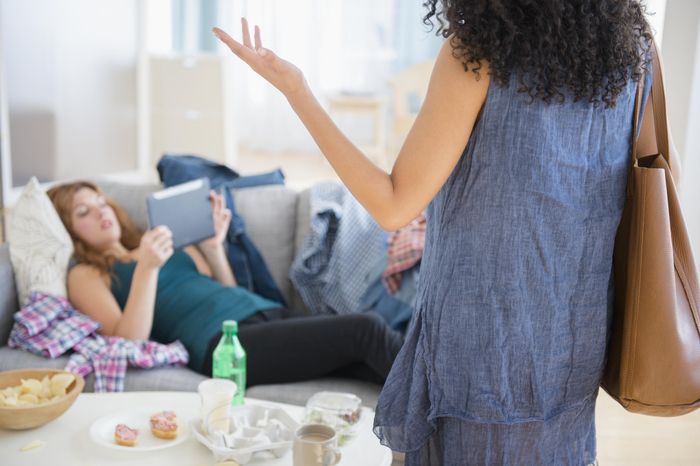 a person attempting to talk to someone who is distracted by a tablet and ignoring them