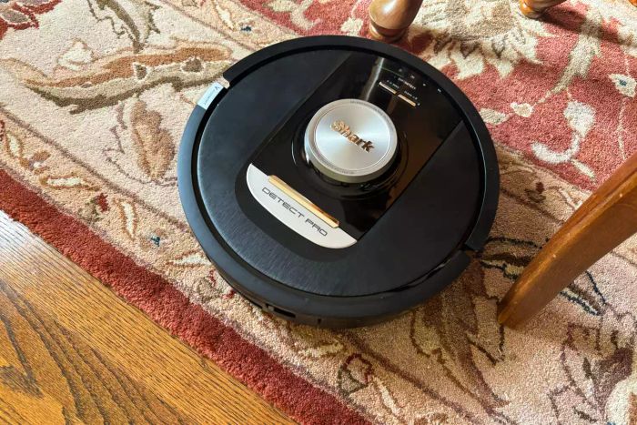 A top-down view of the Shark RV2820AE Detect Pro Self-Empty Robot Vacuum on a carpet.