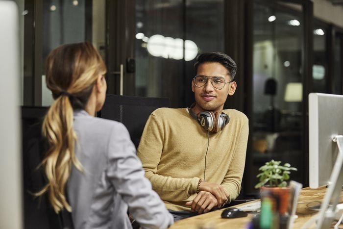 two colleagues having a conversation in an office