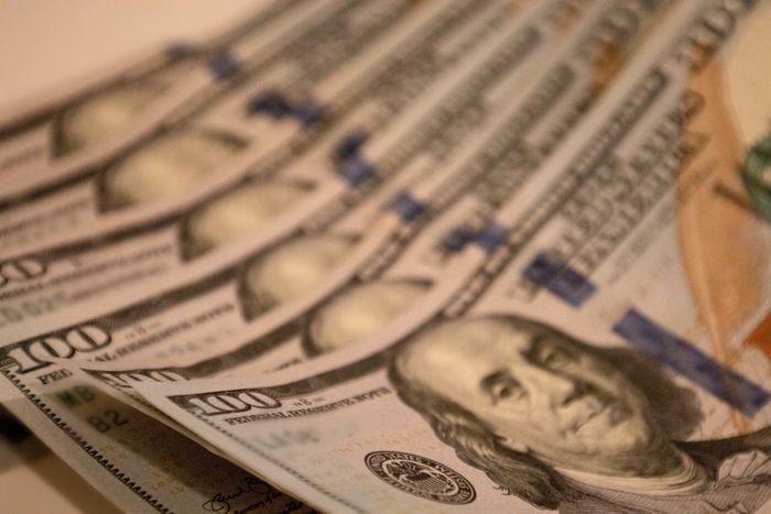 A pile of $100 bills neatly arranged