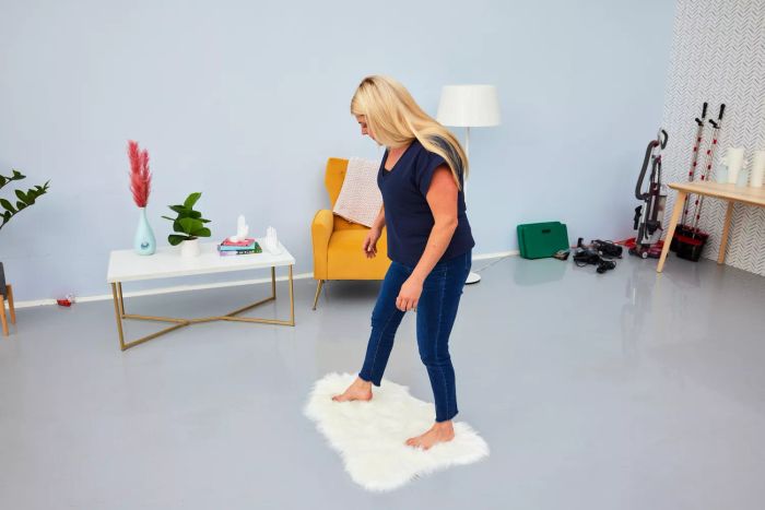 A person walking barefoot on the Ashler Faux Fur Rug
