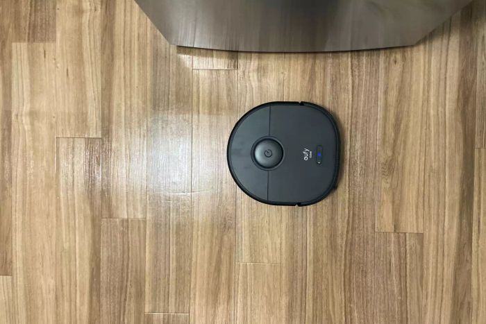 A bird's-eye view of the Eufy Clean X9 Pro Robotic Vacuum as it cleans a wooden floor.