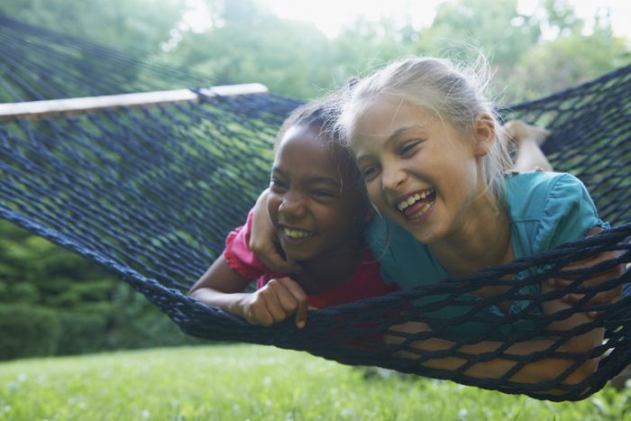 children relaxing on a hammock