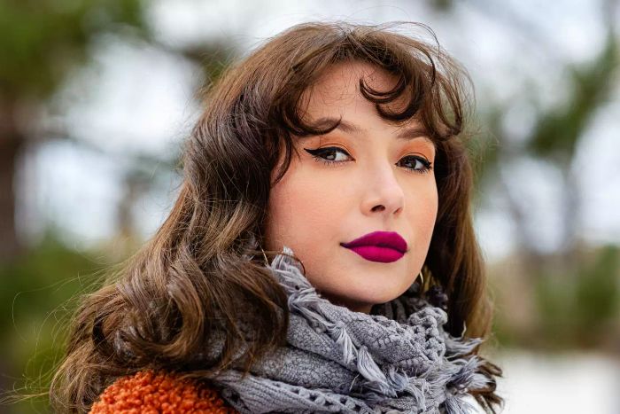 woman wearing deep cranberry lipstick