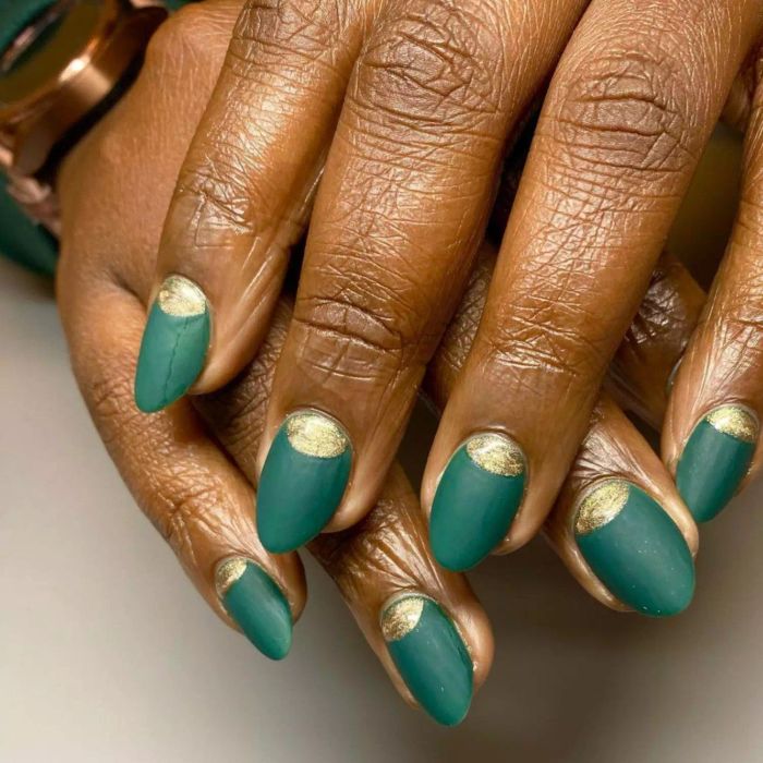 Matte green manicure with gold half-moons.