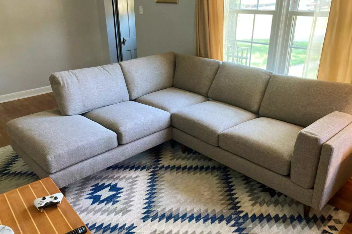The BenchMade Modern Skinny Fat Sectional with Bumper arranged in a living room