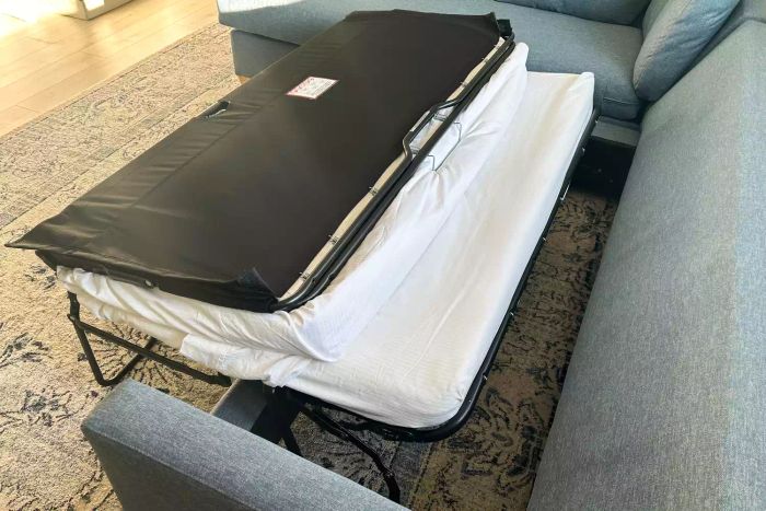 The bed of the Apt2B Tuxedo 2-Piece Sleeper Sectional is partially extended, showcasing its transformation from sectional to bed.