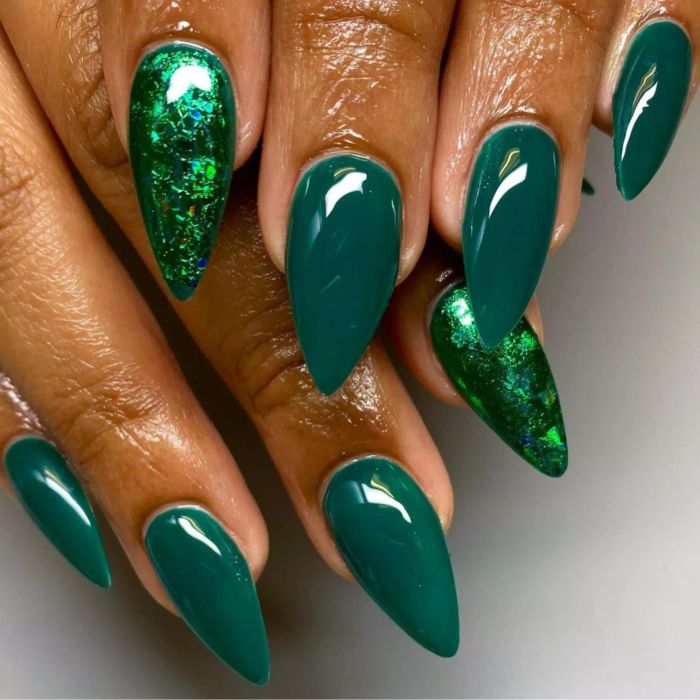 Emerald green nails with a glittery green accent nail on the pointer finger.