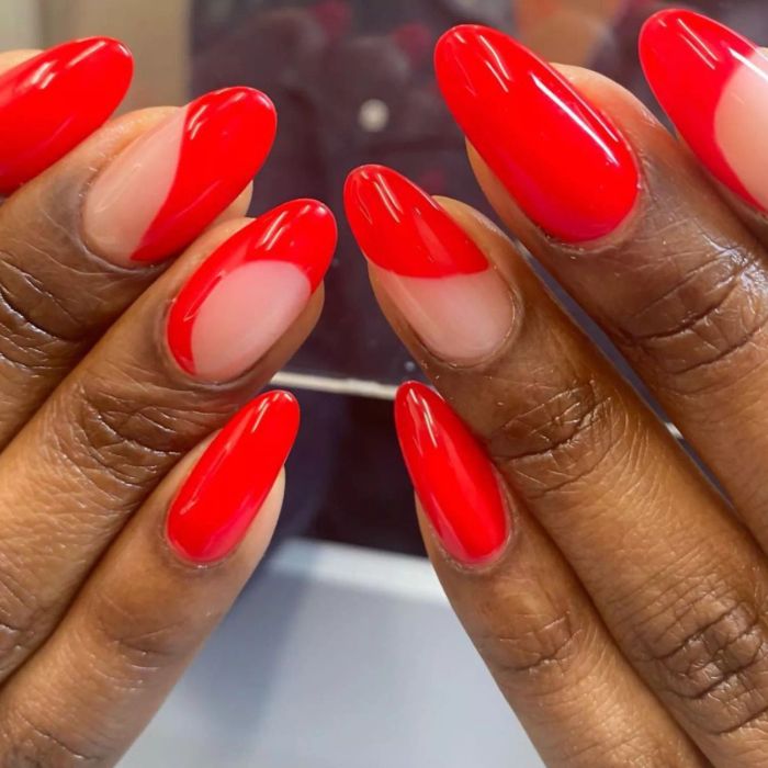 Red manicure with swirls.