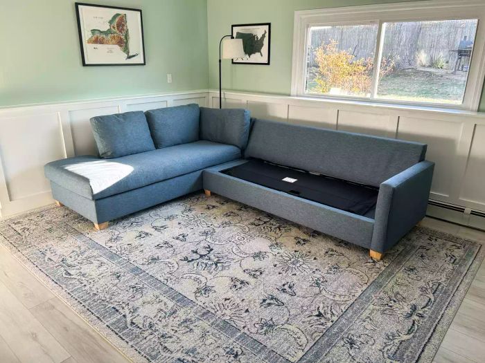 The Apt2B Tuxedo 2-Piece Sleeper Sectional is shown on a patterned rug, with one cushion removed for a closer look.