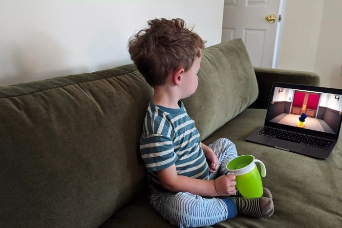 A child enjoys sitting on the Maiden Home The Varick Couch.