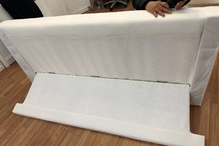 A person putting together the IKEA Uppland Sofa