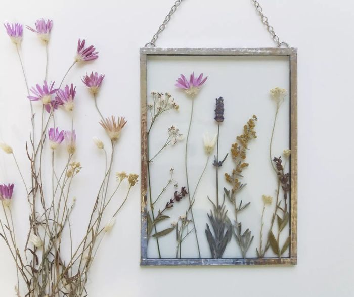 Pressed and framed wildflowers make a beautiful, personal gift. Whether it's a token from a memorable trip, flowers from a meaningful spot, or simply a lovely art piece, framing them between glass creates a timeless keepsake.