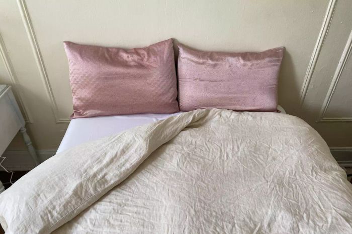 The Fluff Co Down Blended Comforter displayed on a bed